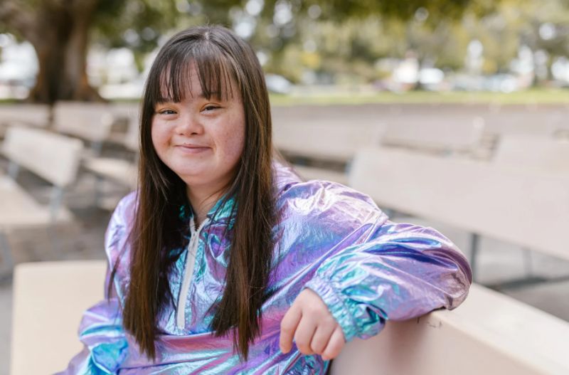 A woman with a disability smiling at the camera