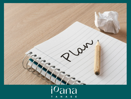 A notebook with a ripped page nearby. On the page open the word "plan" written next to a pencil. 