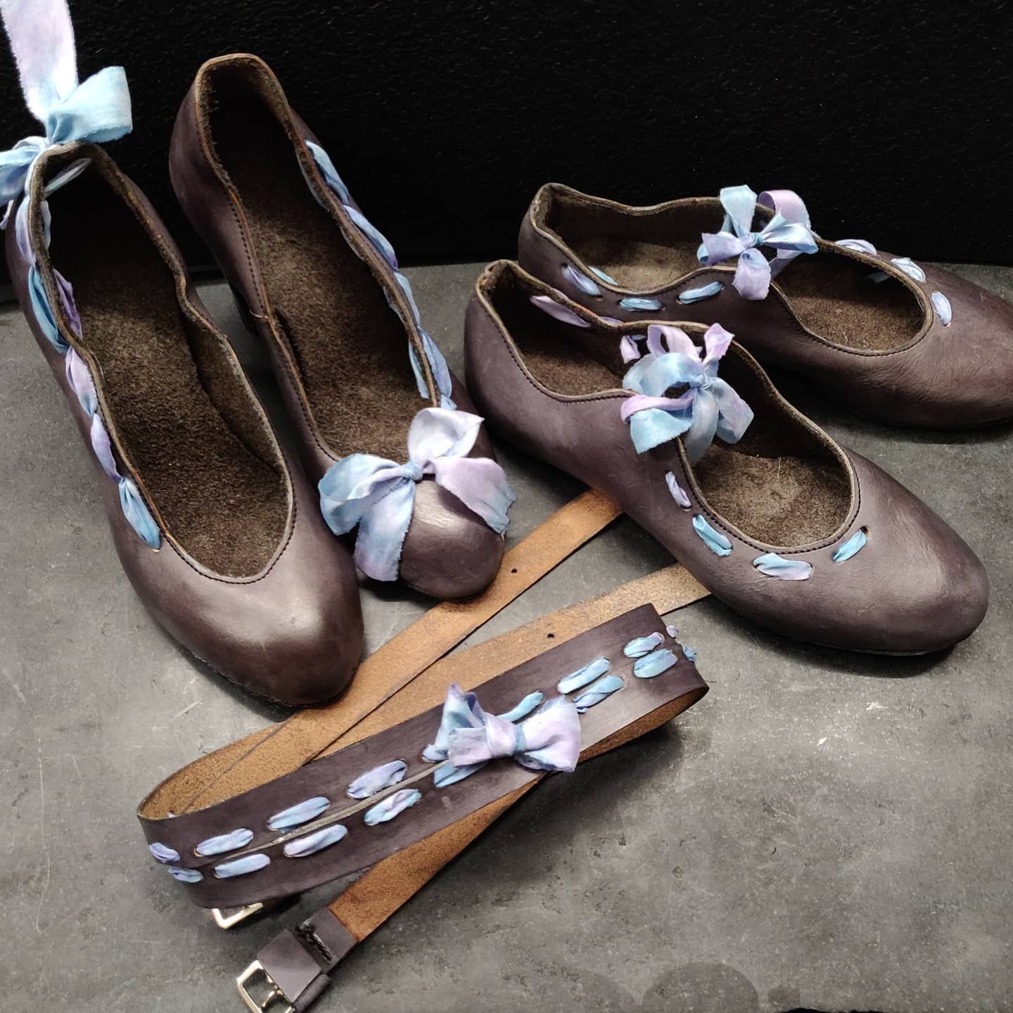 The full collection of all ribboned up including pumps, flat and a ribbon. All in grey leather with ribbons in a soft purple blue. 