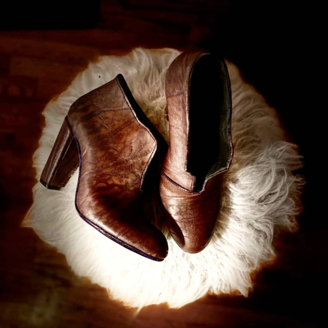 Boots against a fluffy mat which the light on them and accentuating the animal print
