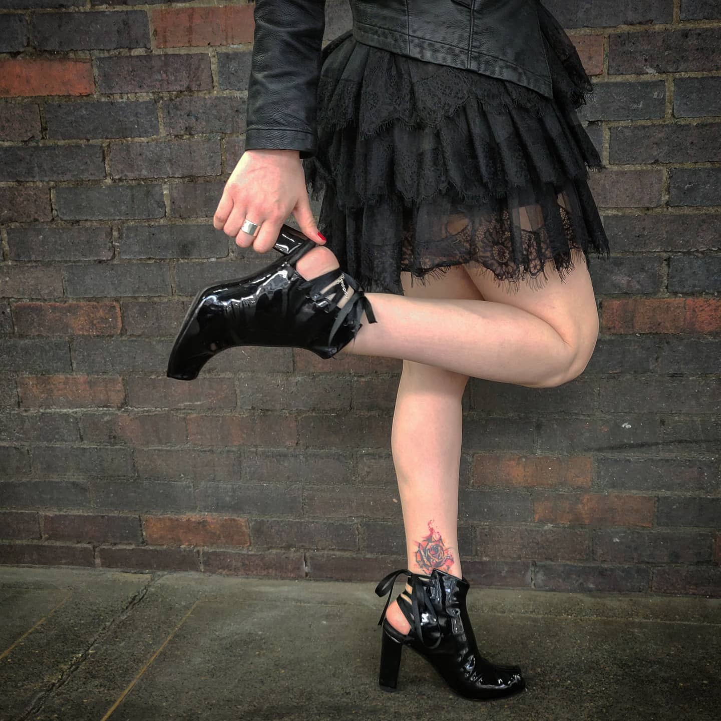 Modelling the shoes with a tulle short skirt and leather jacket