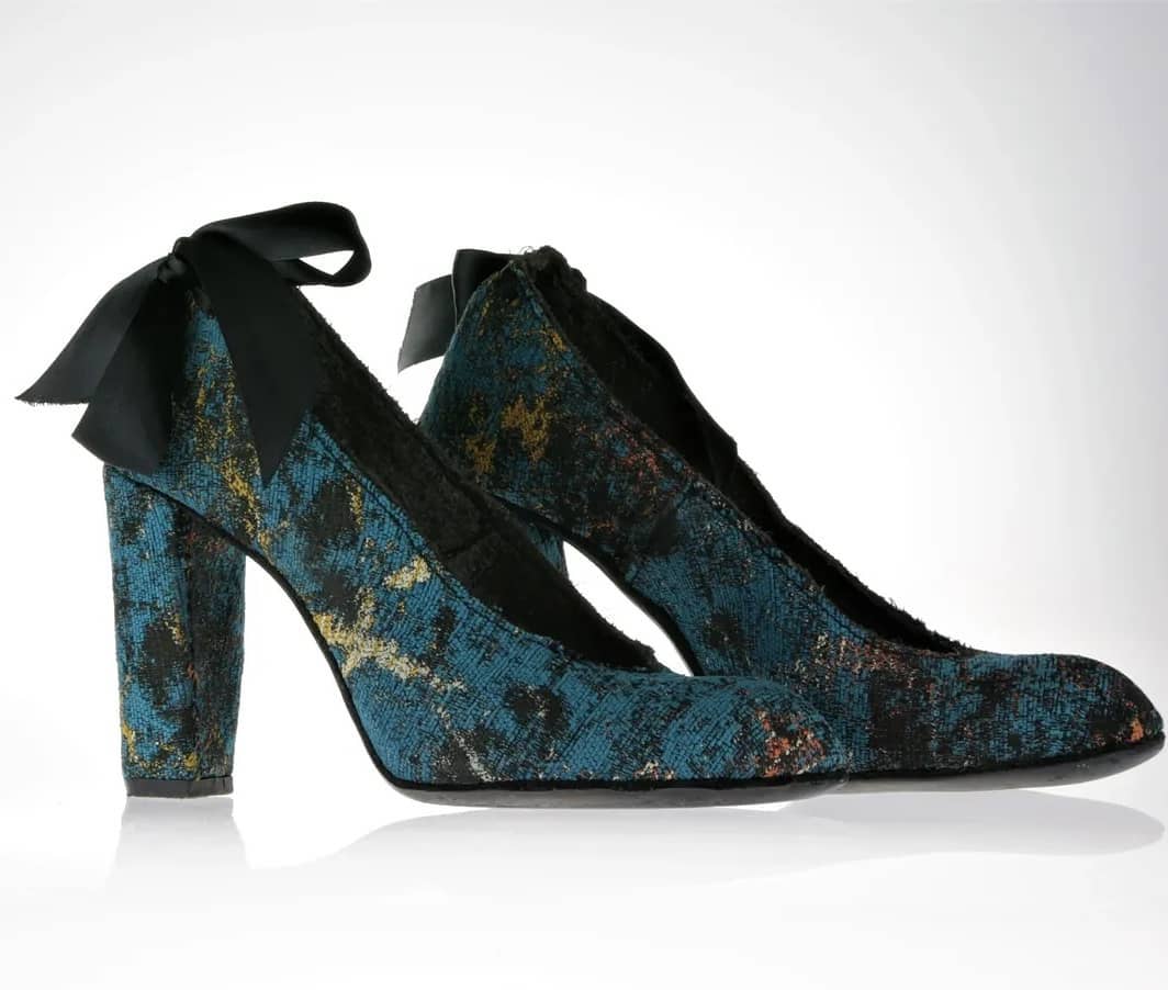 Pumps in a abstract fabric with predominately blue hues and some gold and auburn accents. The heel is 10cm covered in the same fabric. Optional black satin ribbons at the back above the heel area