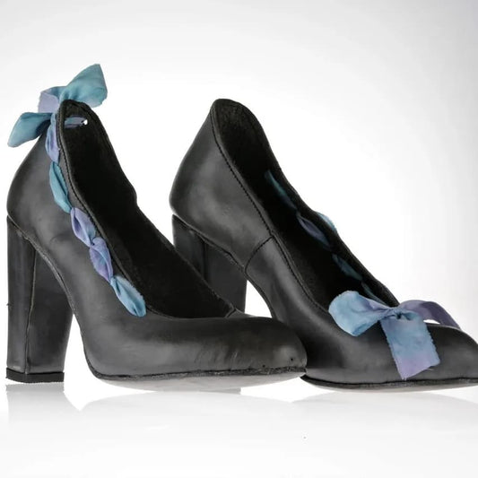 Grey leather pumps with asymmetric ribbons - on one shoe on the front and on the other at the black. The ribbons are hand dyed silks with hues of blue and purple, giving it a delicate contrast with the leather's grey. 10cm block heel covered in the same leather