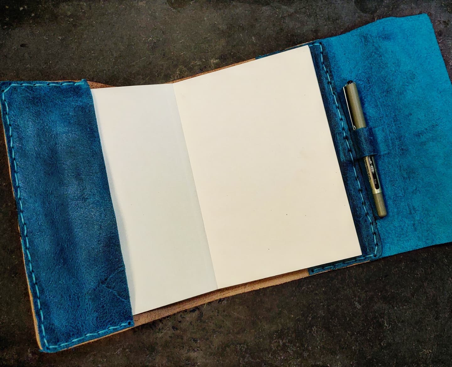 Opened journal view with blue and blue suede leather
