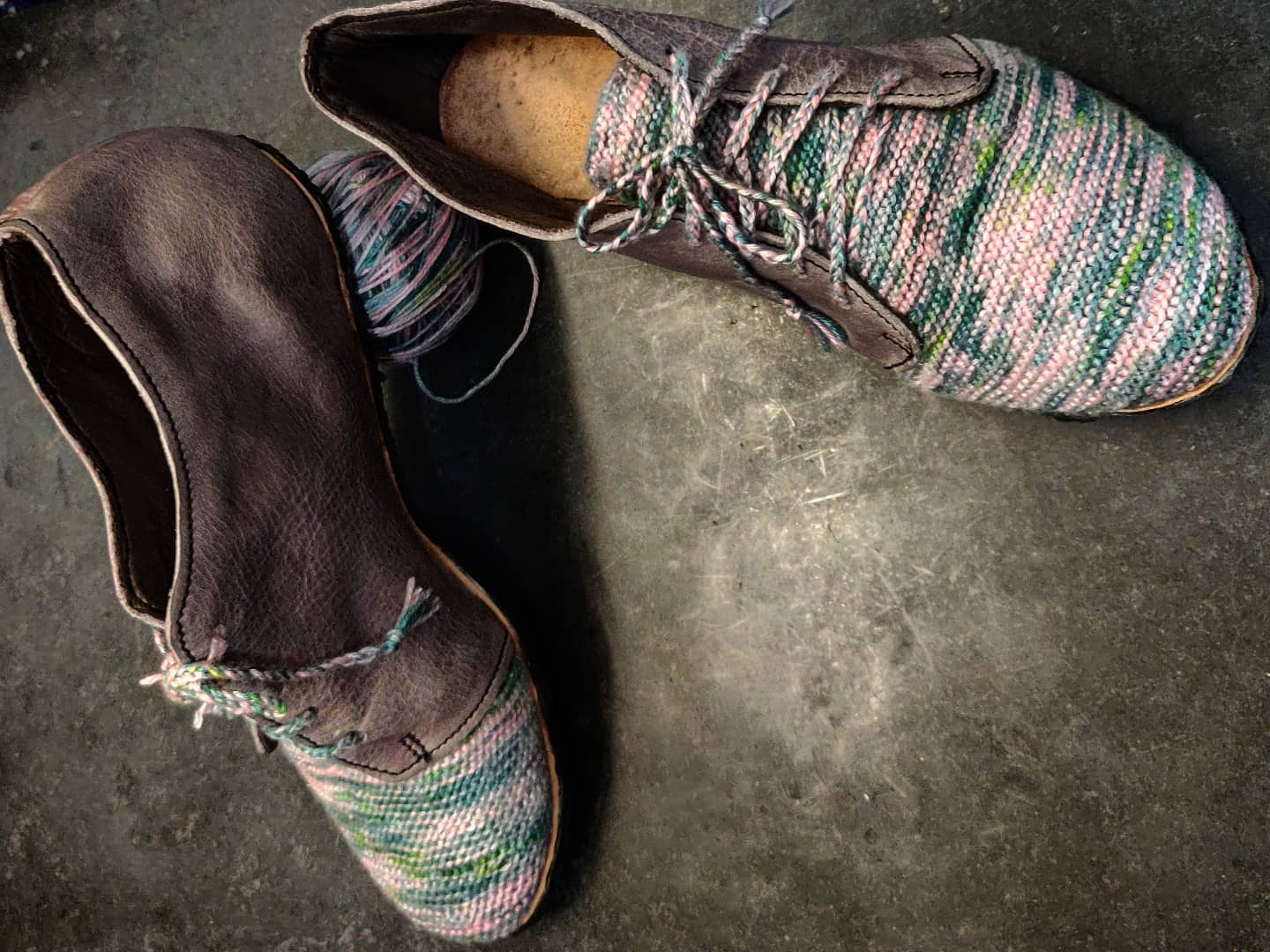Display of the same shoes with one of them prompt against a ball of yawn to showcase the sole is straight with no lifts and includes Vibram soling 