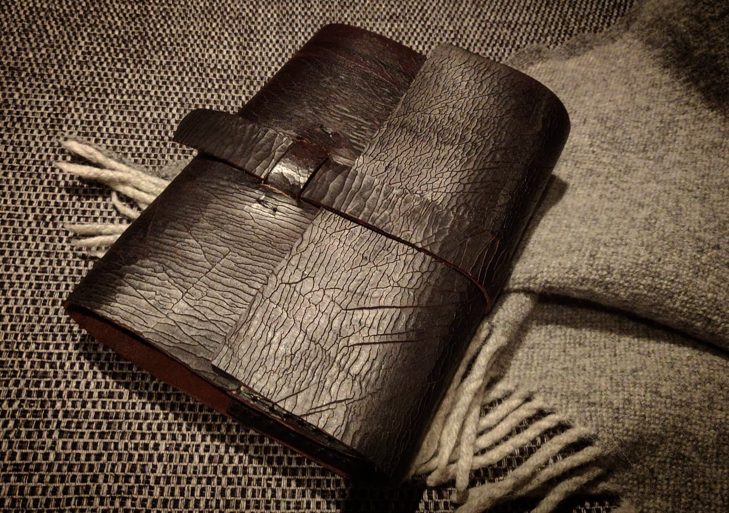 The journal against a blanket and sofa