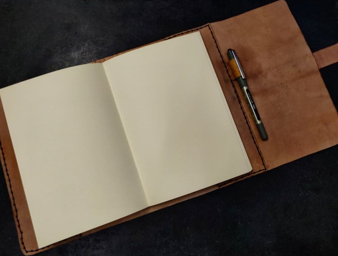 Open journal detailing the white pages against the leather 