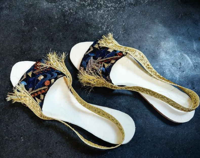 Slippers with band of fabric at the front (and open toes similar to other slipper designs). They also have a golden band from the front around the ankle and back to the front for asthetic reasons