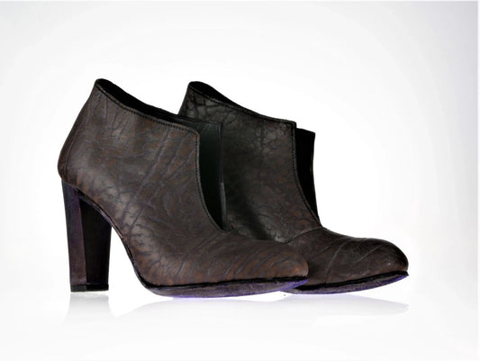 This boots have an interesting leather with almost animal print like detailing which is very subtle. The color of the leather is somewhere between purple and dark redish brown, and the sole and heel are purple to accentuate some of the shades of the leather. This pair has a block 10cm maple heel. The boot has a dramatic opening on the front which removes the need for zips or laces